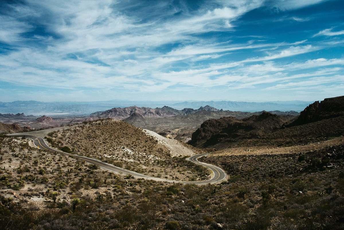 oatman curved road in between bushes dirt road